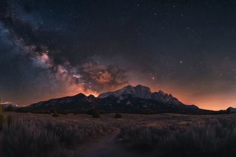 A stunning night sky reveals the Milky Way above the majestic mountains in Colorado at dusk