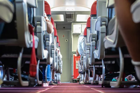 Passengers traveling by a plane, shot from the inside of an airplane