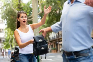 Man street robbery pulling woman backpack on street