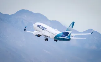 WestJet aircraft C-GWBT Boeing 737-700 taking off from Harry Reid International