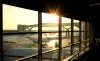 Airport departure lounge with passenger plane being loaded.